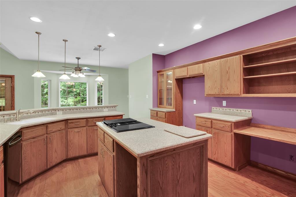 2255 Davy Lane Denison, TX 75020 - Photo 19 of 37 a kitchen with a stove a sink a refrigerator and wooden cabinets