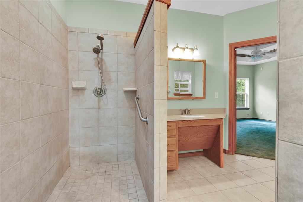 2255 Davy Lane Denison, TX 75020 - Photo 24 of 37 a bathroom with a sink and a mirror