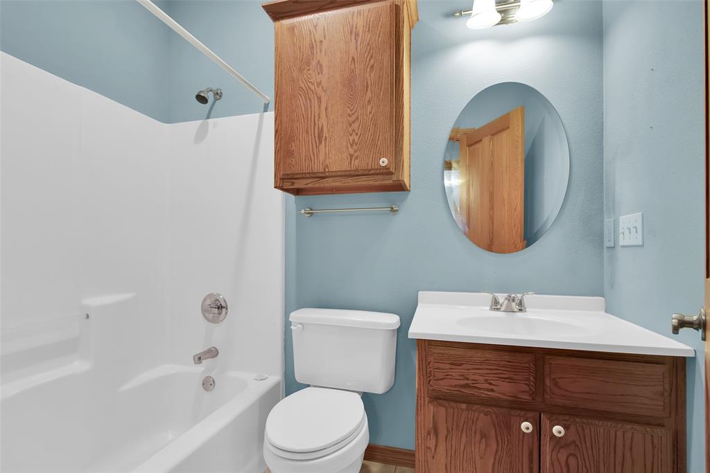 2255 Davy Lane Denison, TX 75020 - Photo 26 of 37 a bathroom with a sink vanity mirror and toilet