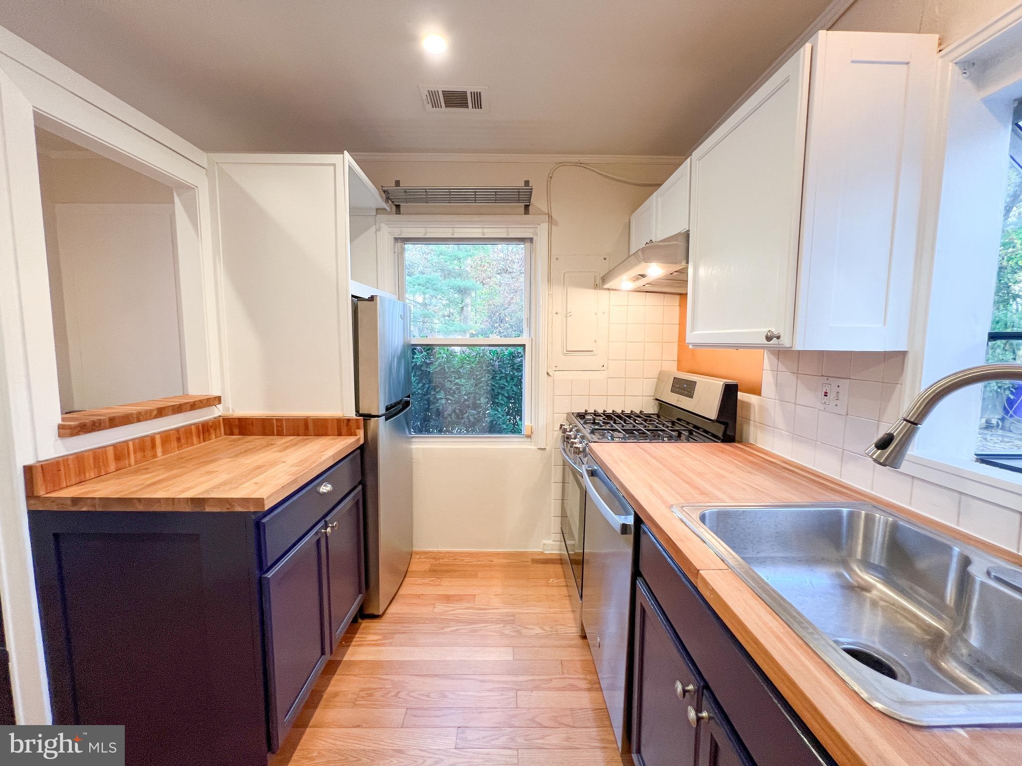 3000 Edgewood Road Kensington, MD 20895 - Photo 13 of 28 a kitchen with stainless steel appliances granite countertop a sink and a stove