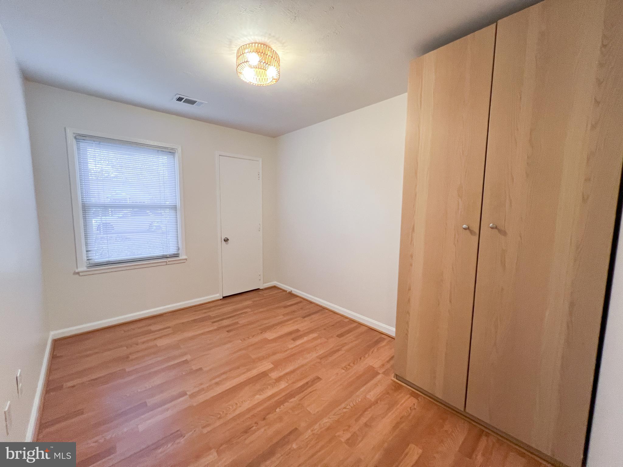 3000 Edgewood Road Kensington, MD 20895 - Photo 18 of 28 an empty room with wooden floor and windows