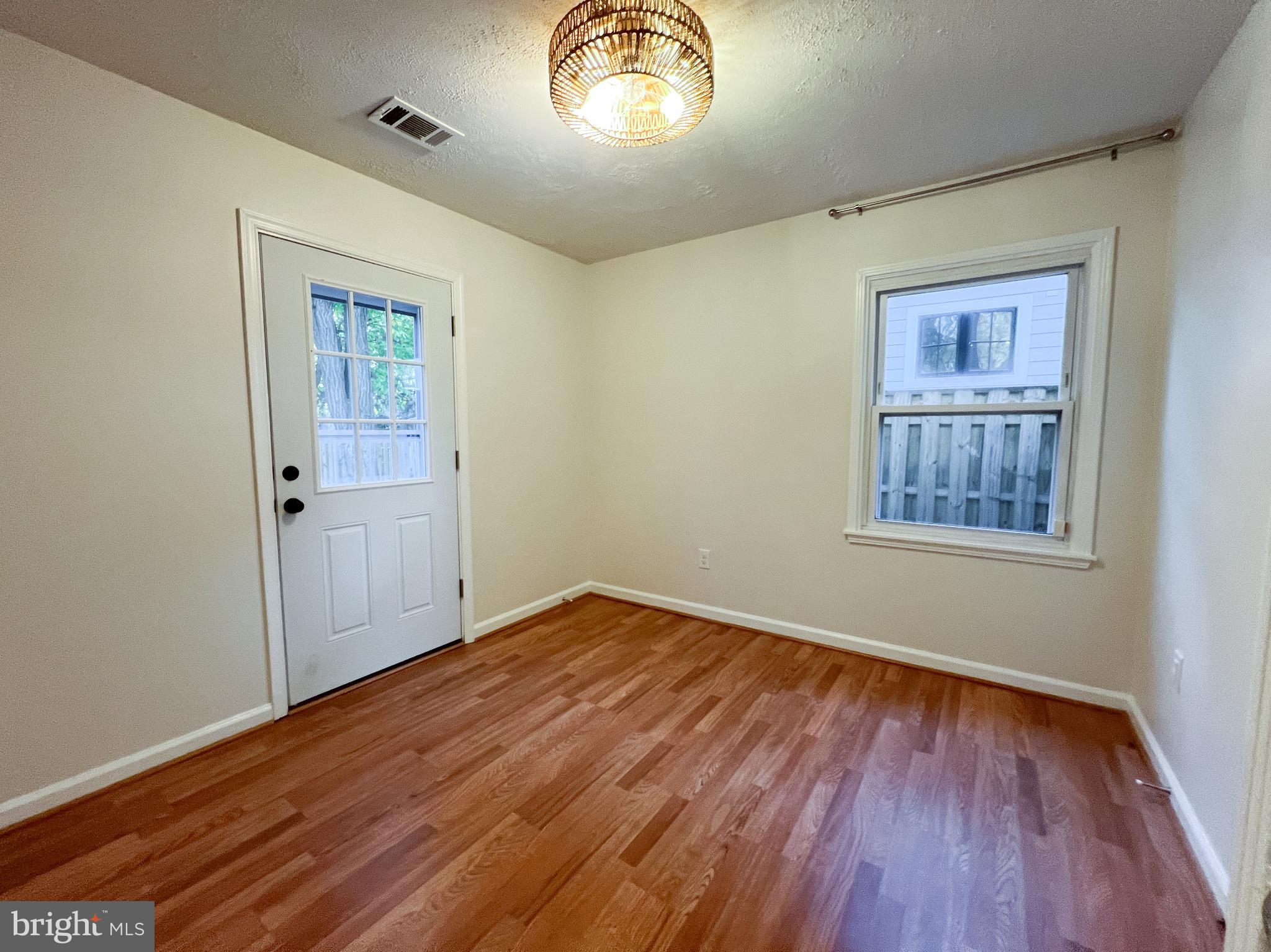 3000 Edgewood Road Kensington, MD 20895 - Photo 20 of 28 wooden floor in an empty room with a window