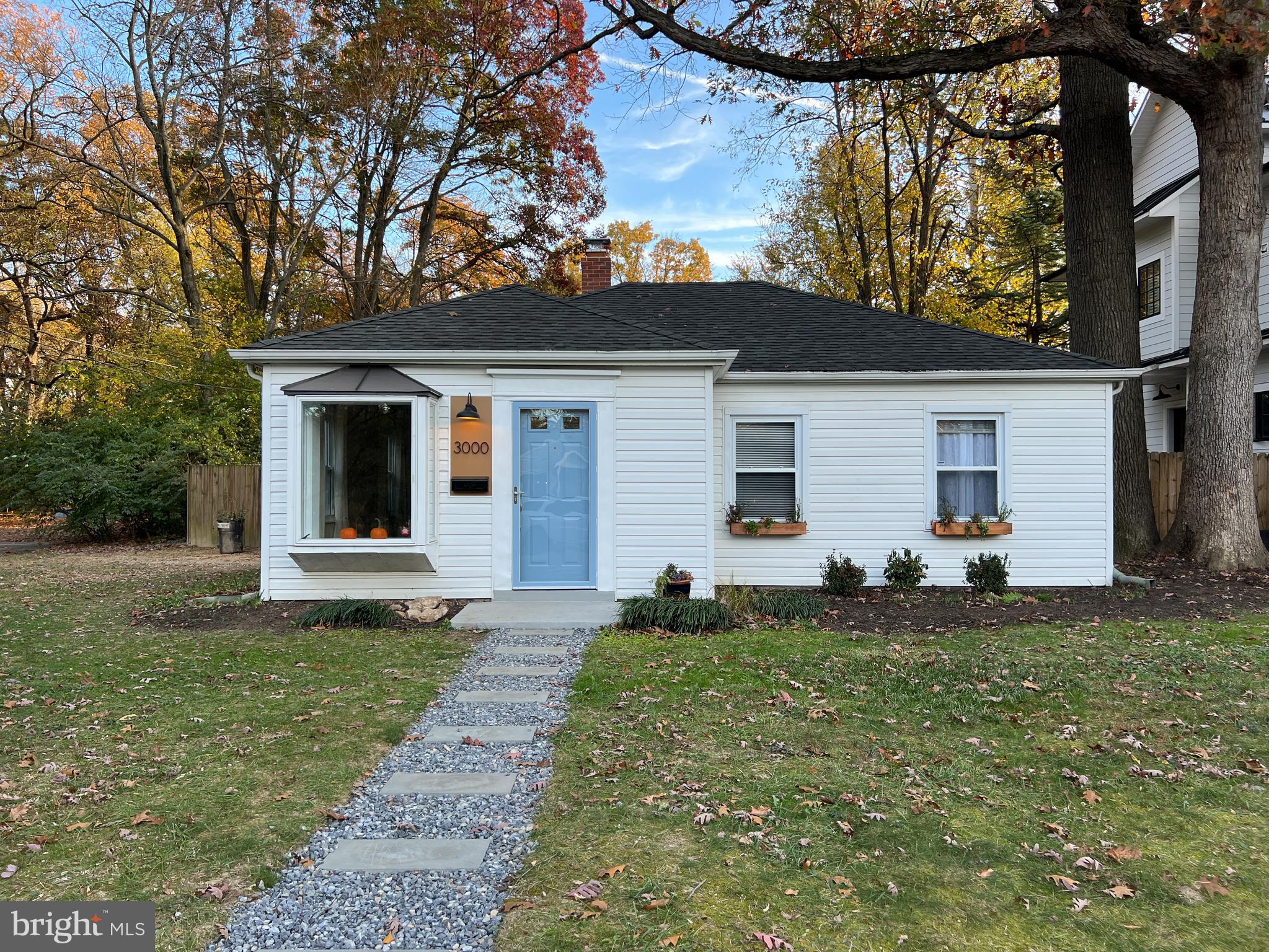 3000 Edgewood Road Kensington, MD 20895 - Photo 2 of 28 a view of a white house in front of a big yard with large windows