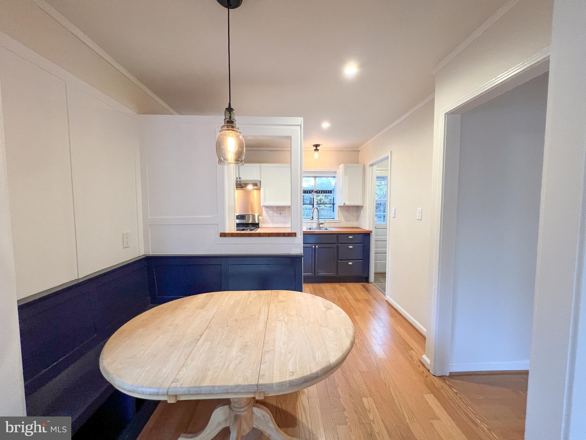 3000 Edgewood Road Kensington, MD 20895 - Photo 8 of 28 a room with a table and chandelier