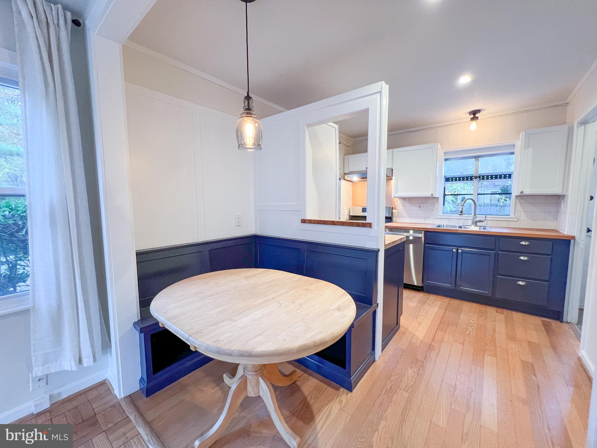 3000 Edgewood Road Kensington, MD 20895 - Photo 9 of 28 a room with stainless steel appliances kitchen island granite countertop wooden cabinets a stove a sink and a window