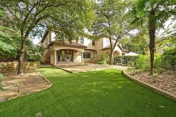 a view of a pathway with house and garden