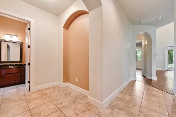 a bathroom with a granite countertop sink toilet and mirror