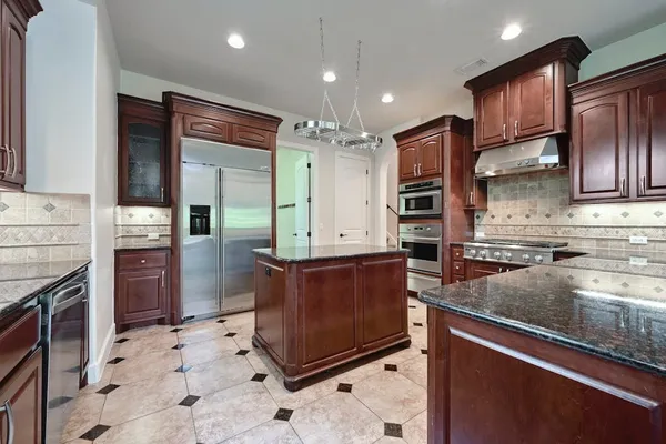 a kitchen with a stove a sink and a refrigerator