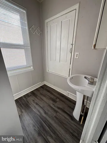 a view of an entryway with wooden floor
