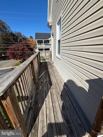 a view of a balcony with wooden floor and city view