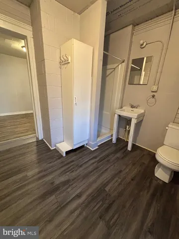 a view of a bathroom with wooden floor and a toilet