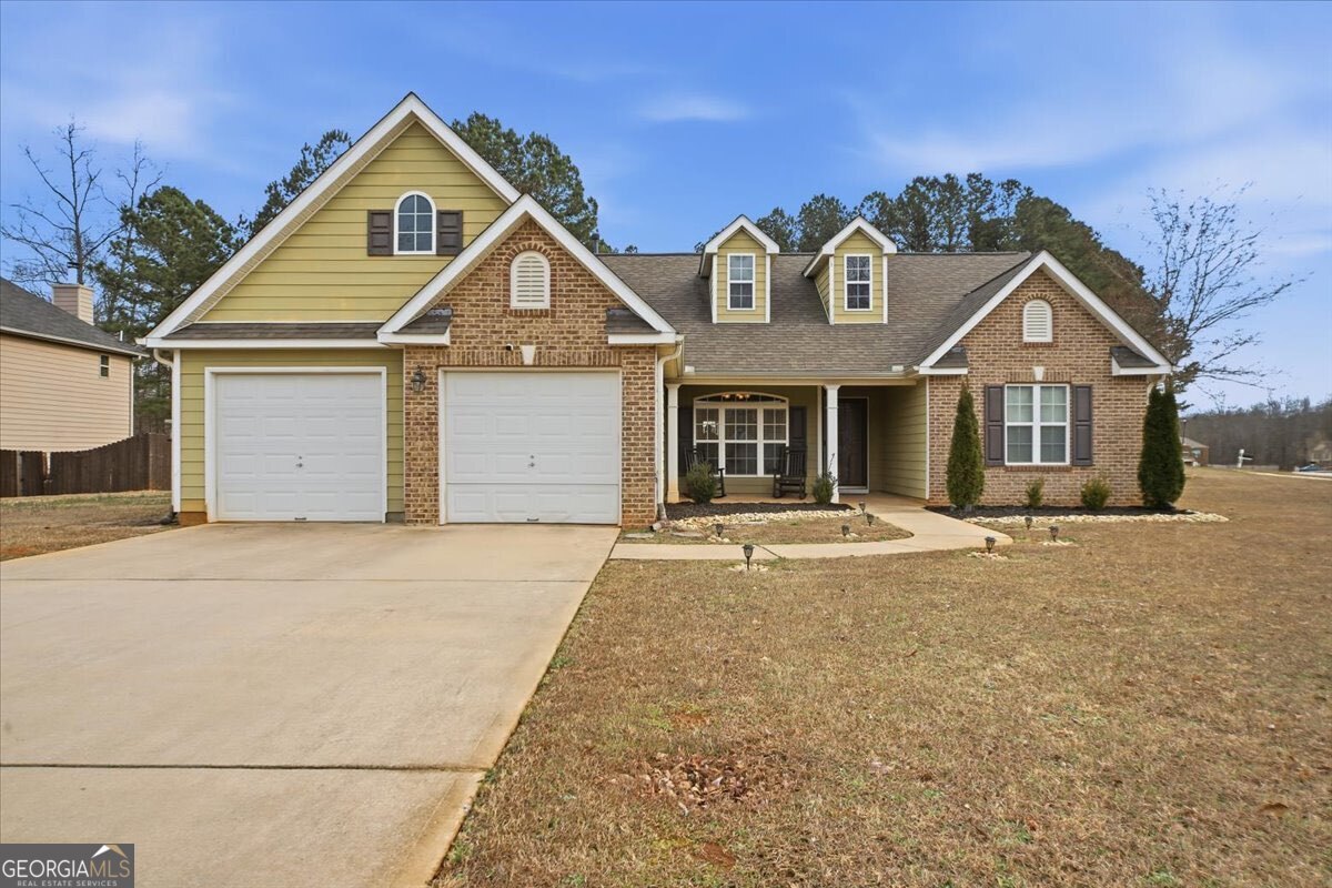 a front view of a house with a yard and garage