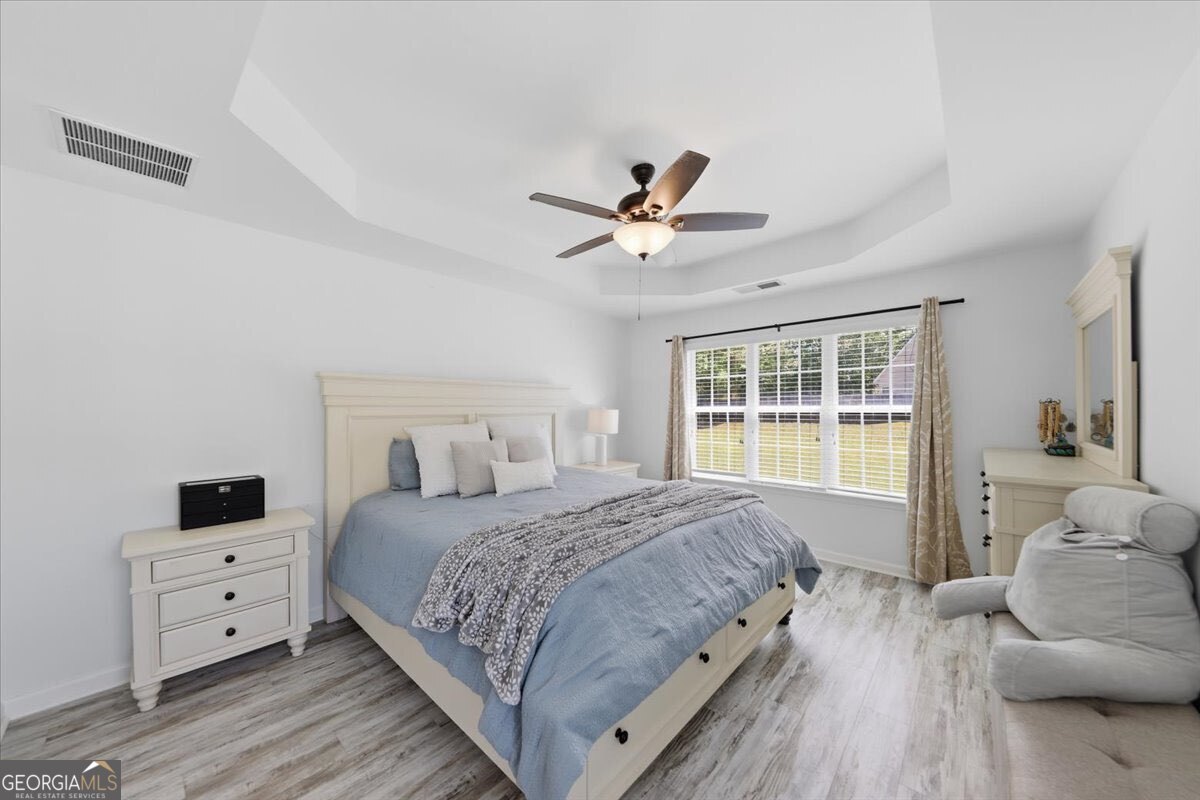 1201 Pendley Point Hampton, GA 30228 - Photo 11 of 23 a bedroom with a bed and a window