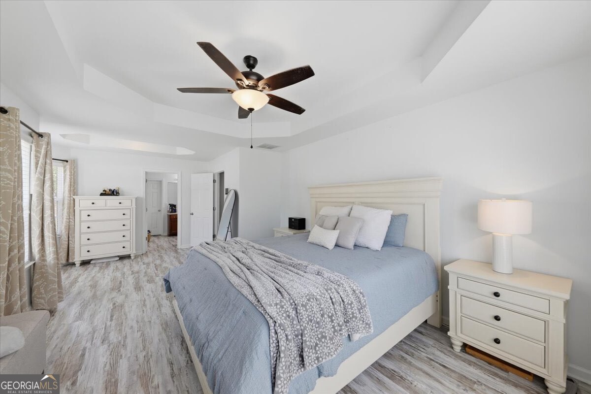 1201 Pendley Point Hampton, GA 30228 - Photo 13 of 23 a bedroom with a bed and a chandelier