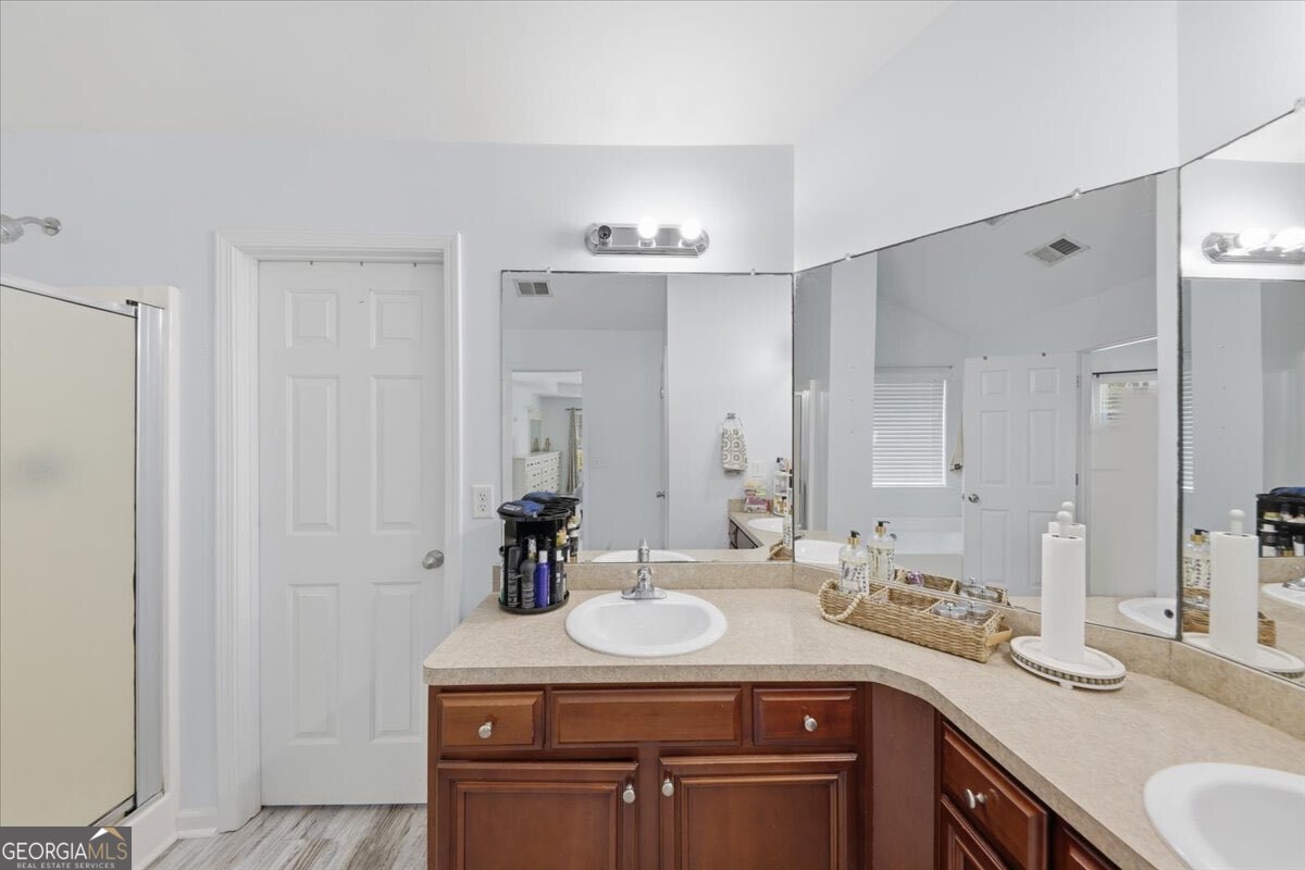 1201 Pendley Point Hampton, GA 30228 - Photo 16 of 23 a bathroom with a granite countertop sink and a mirror