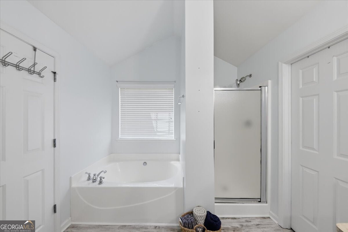 1201 Pendley Point Hampton, GA 30228 - Photo 17 of 23 a bathroom with a bathtub and a shower