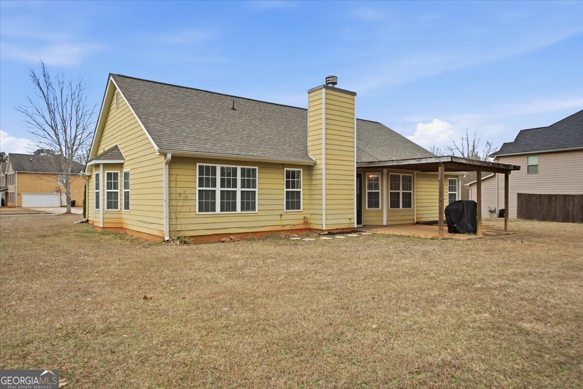 1201 Pendley Point Hampton, GA 30228 - Photo 21 of 23 a front view of a house with a garden