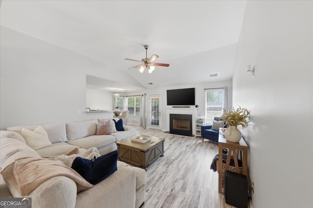 1201 Pendley Point Hampton, GA 30228 - Photo 3 of 23 a living room with furniture a fireplace and a flat screen tv