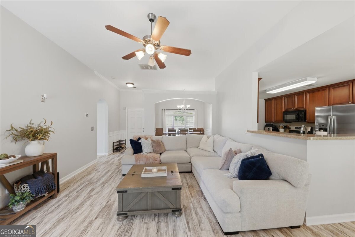 1201 Pendley Point Hampton, GA 30228 - Photo 5 of 23 a living room with furniture and a view of kitchen