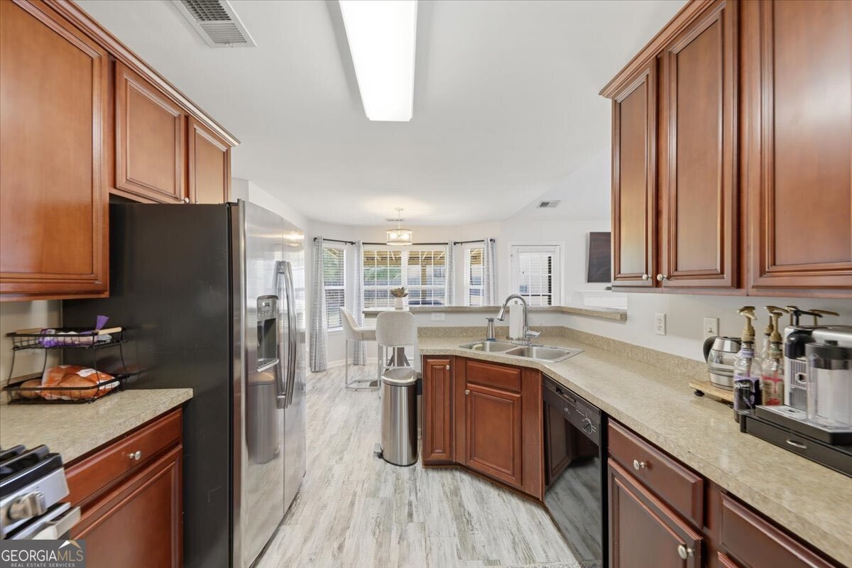 1201 Pendley Point Hampton, GA 30228 - Photo 7 of 23 a kitchen with a sink refrigerator and cabinets