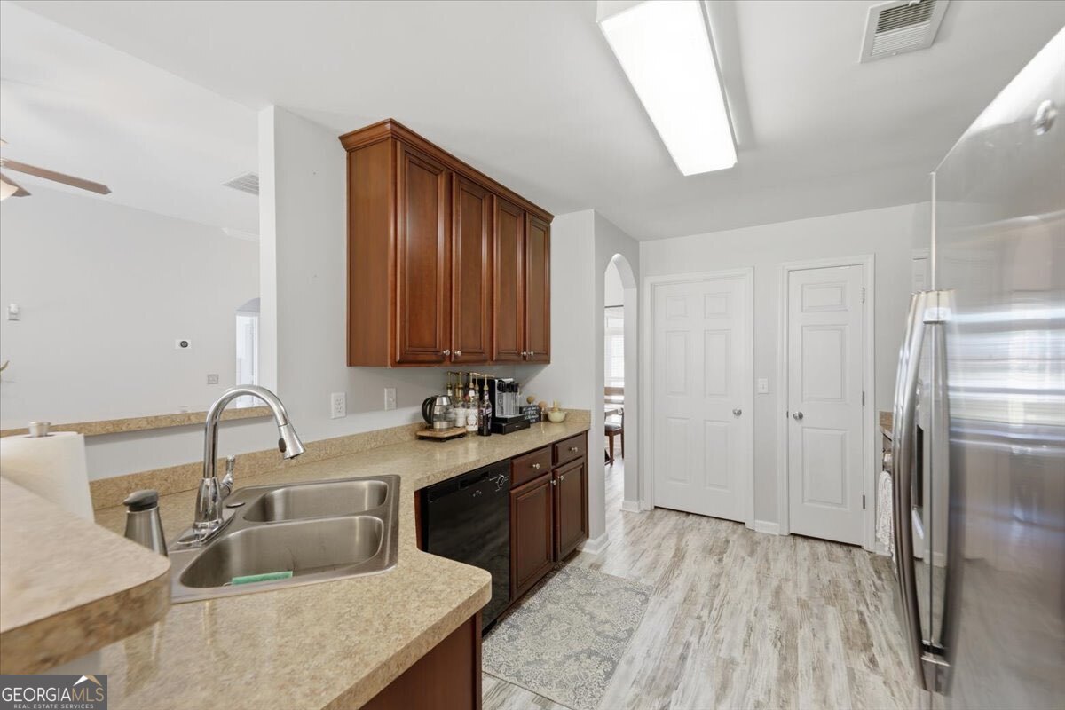 1201 Pendley Point Hampton, GA 30228 - Photo 8 of 23 a kitchen with a sink refrigerator and cabinets