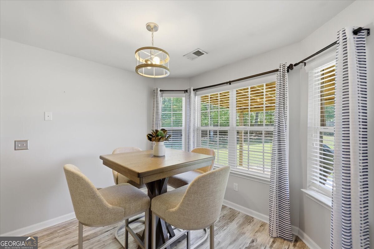 1201 Pendley Point Hampton, GA 30228 - Photo 10 of 23 a view of a dining room with furniture window and wooden floor