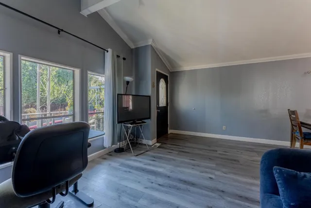 a view of a workspace with furniture and a window