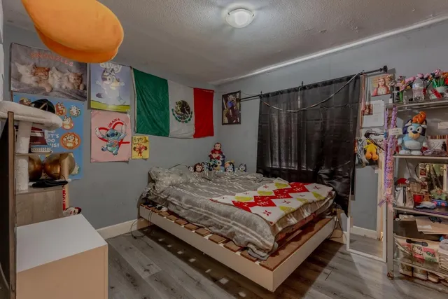 a living room with furniture and a baby crib