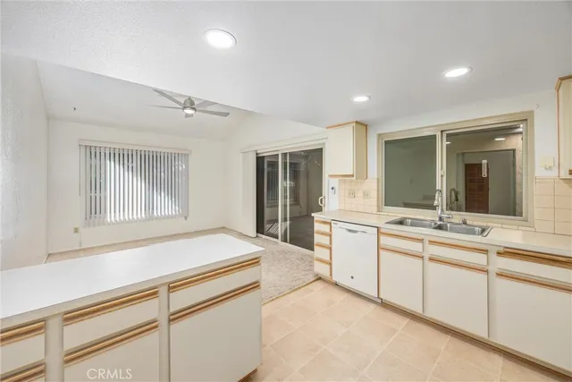 a kitchen with stainless steel appliances white cabinets and a refrigerator
