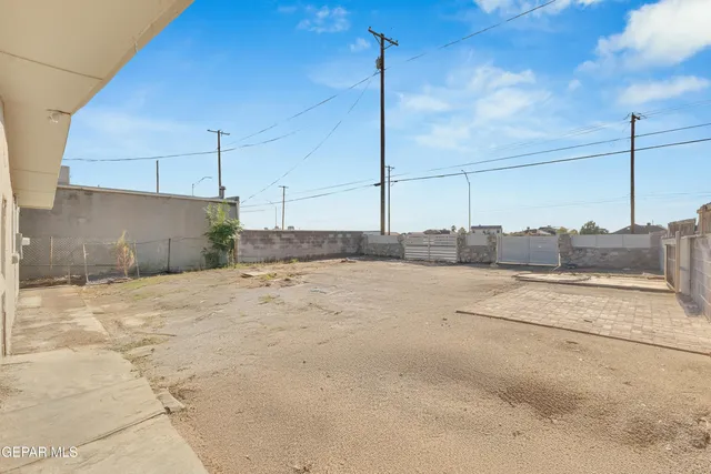 a front view of a house with a dirt yard