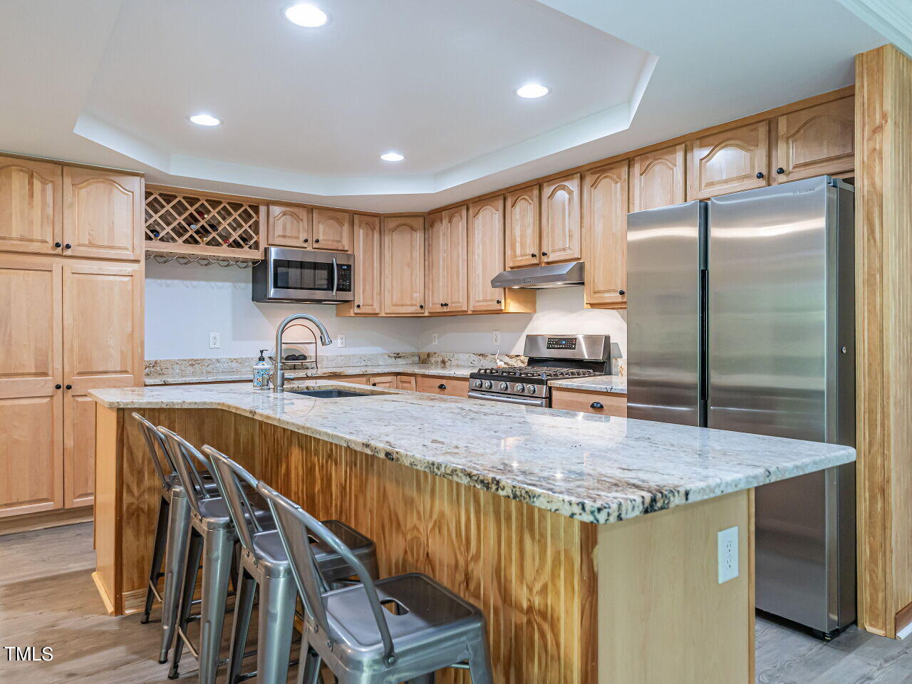 8313 North Creek Run Raleigh, NC 27613 - Photo 17 of 44 Updated Kitchen with granite countertops, stainless steel appliances, massive island and new LVP. Refrigerator conveys.