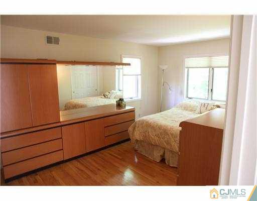 80 Ellmyer Road Edison, NJ 08820 - Photo 16 of 25 a bedroom with a bed and a dresser