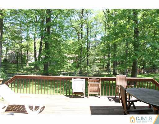 80 Ellmyer Road Edison, NJ 08820 - Photo 22 of 25 a view of backyard with a large trees and wooden fence