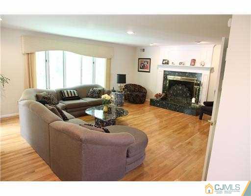 80 Ellmyer Road Edison, NJ 08820 - Photo 6 of 25 a living room with furniture and a fireplace