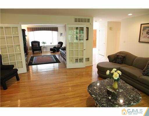 80 Ellmyer Road Edison, NJ 08820 - Photo 7 of 25 a living room with furniture and a large window