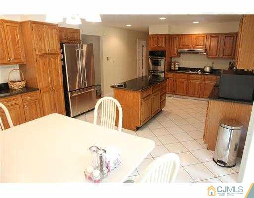 80 Ellmyer Road Edison, NJ 08820 - Photo 8 of 25 a kitchen with stainless steel appliances a refrigerator sink and microwave