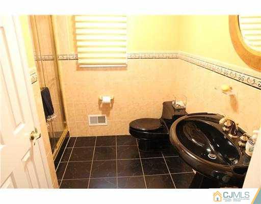 80 Ellmyer Road Edison, NJ 08820 - Photo 10 of 25 a bathroom with a sink a toilet and a mirror