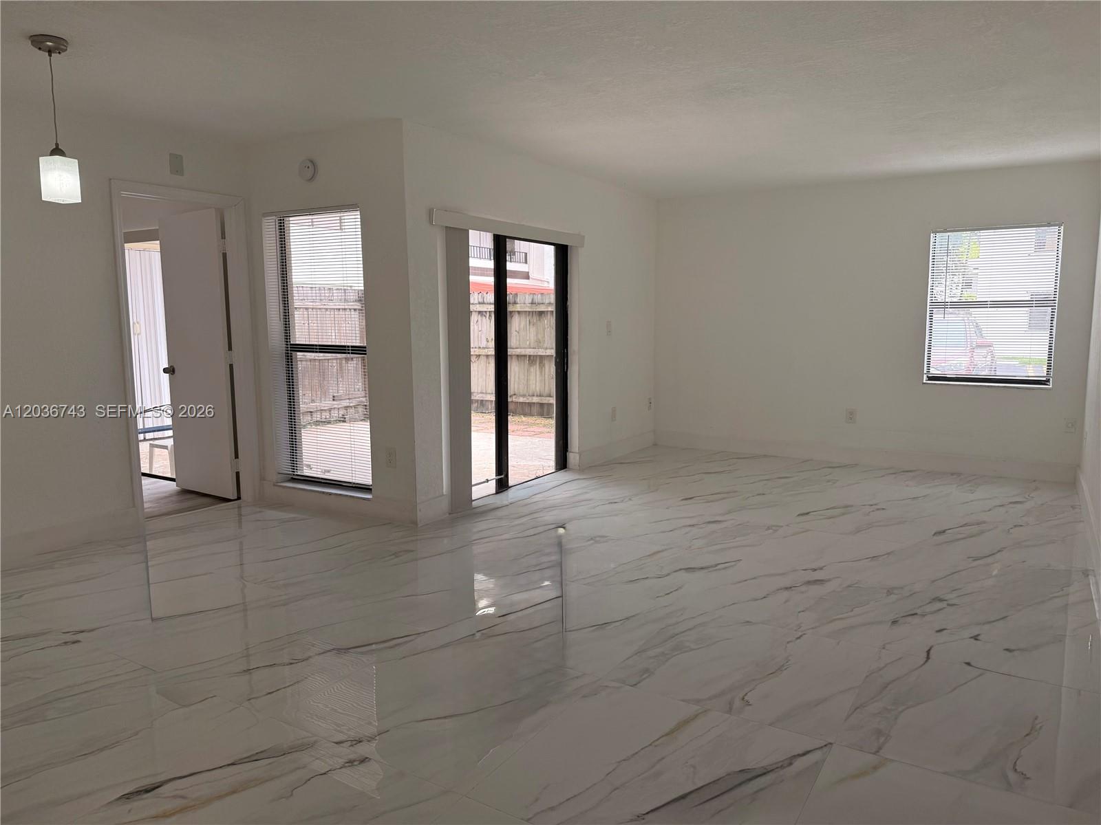 10875 Northwest 7th Street, Unit 1136 Miami, FL 33172 - Photo 4 of 25 an empty room with windows and closet