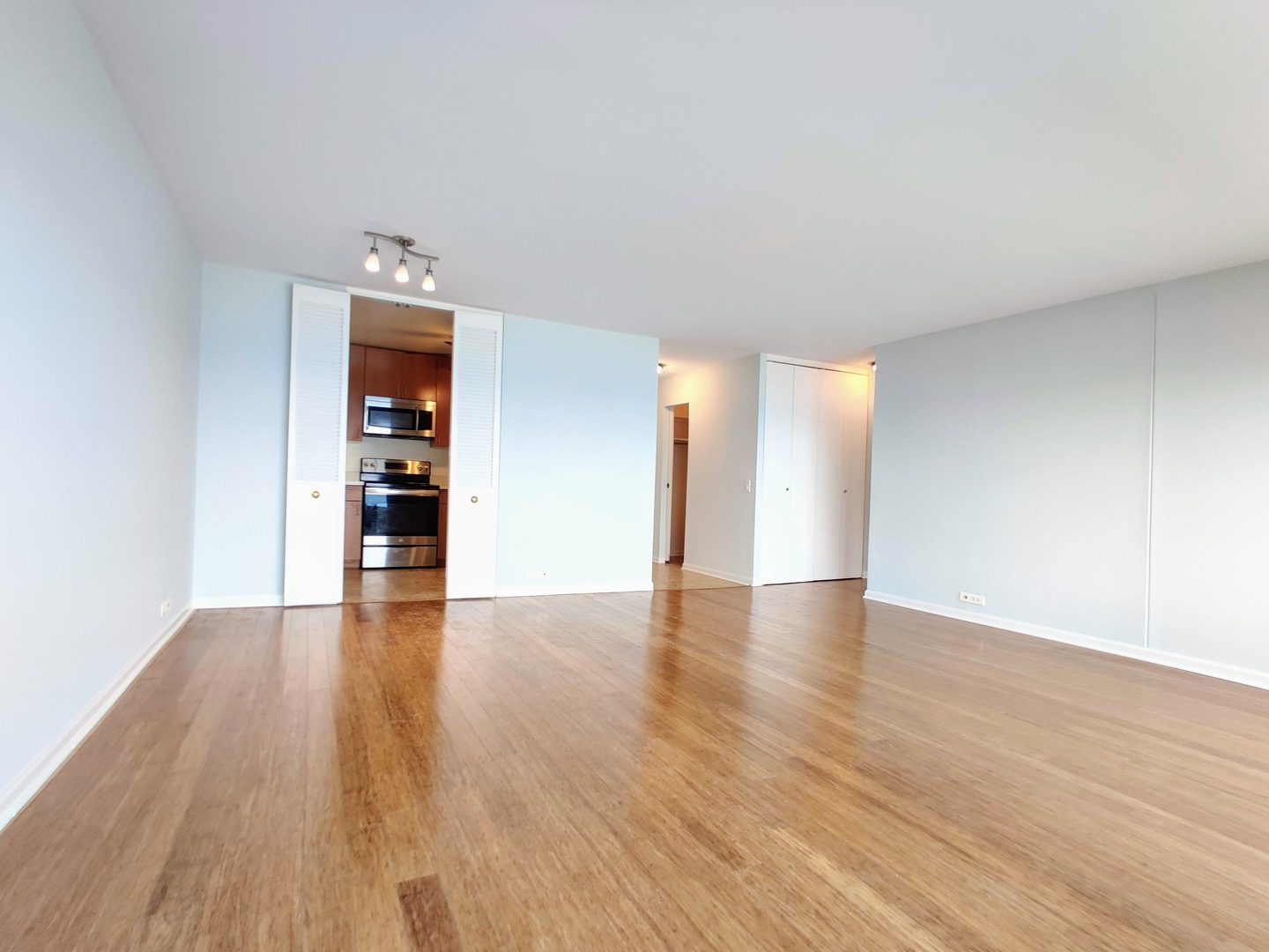 5445 North Sheridan Road, Unit 2504 Chicago, IL 60640 - Photo 14 of 37 a view of an empty room with wooden floor and a window