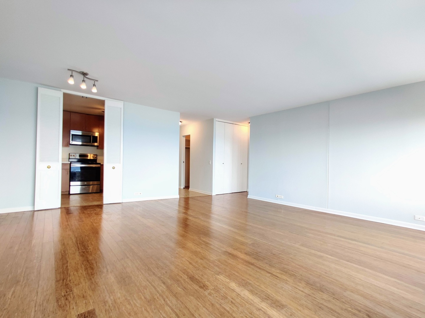 5445 North Sheridan Road, Unit 2504 Chicago, IL 60640 - Photo 15 of 37 a view of an empty room with wooden floor and a window