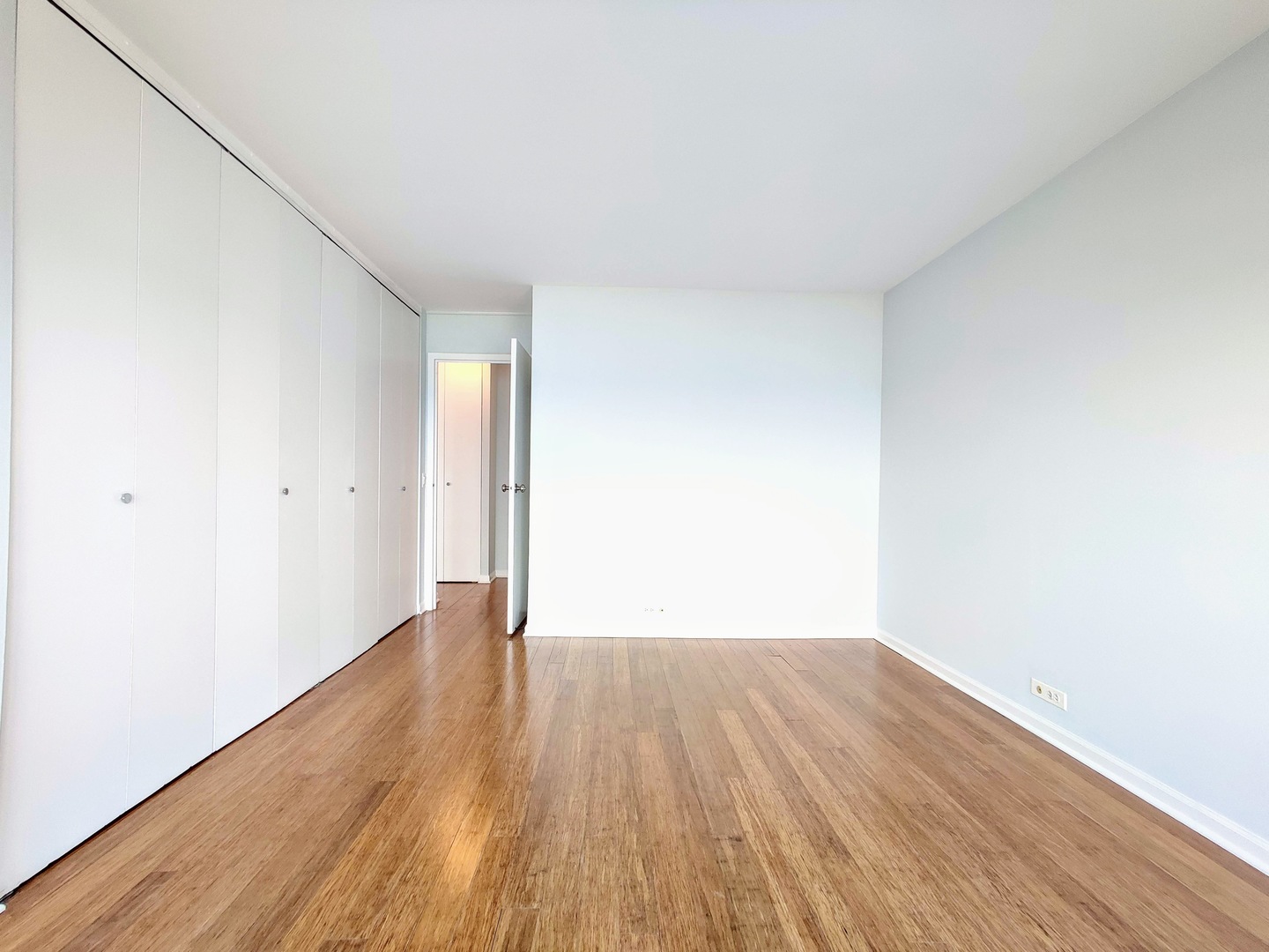 5445 North Sheridan Road, Unit 2504 Chicago, IL 60640 - Photo 23 of 37 a view of an empty room with wooden floor