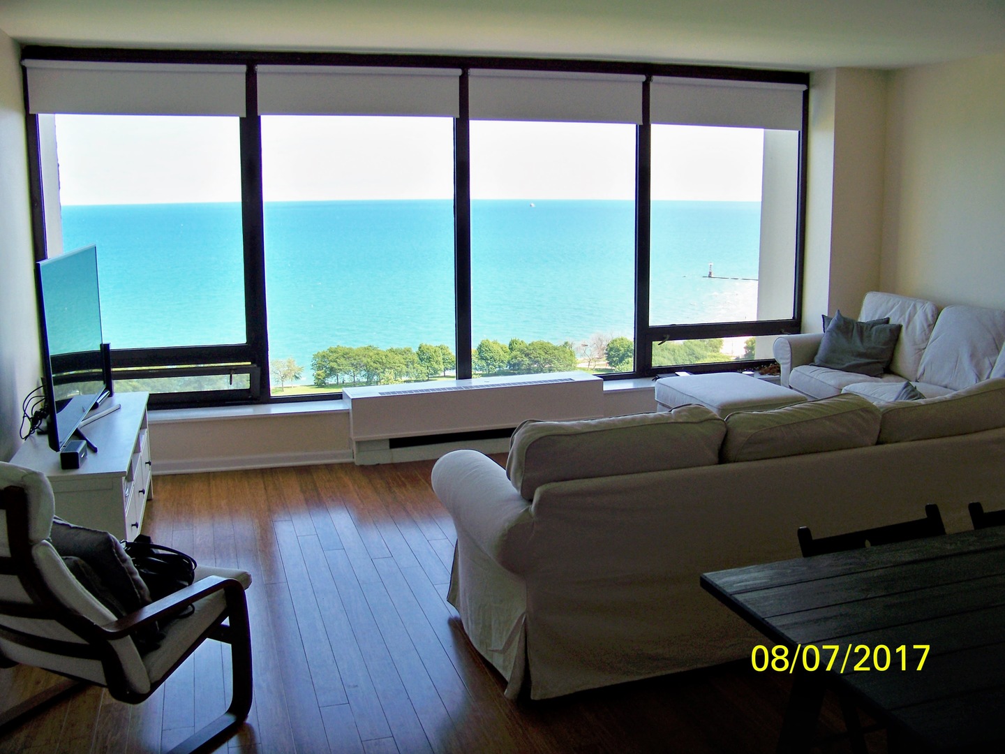 5445 North Sheridan Road, Unit 2504 Chicago, IL 60640 - Photo 4 of 37 a living room with furniture and a large window