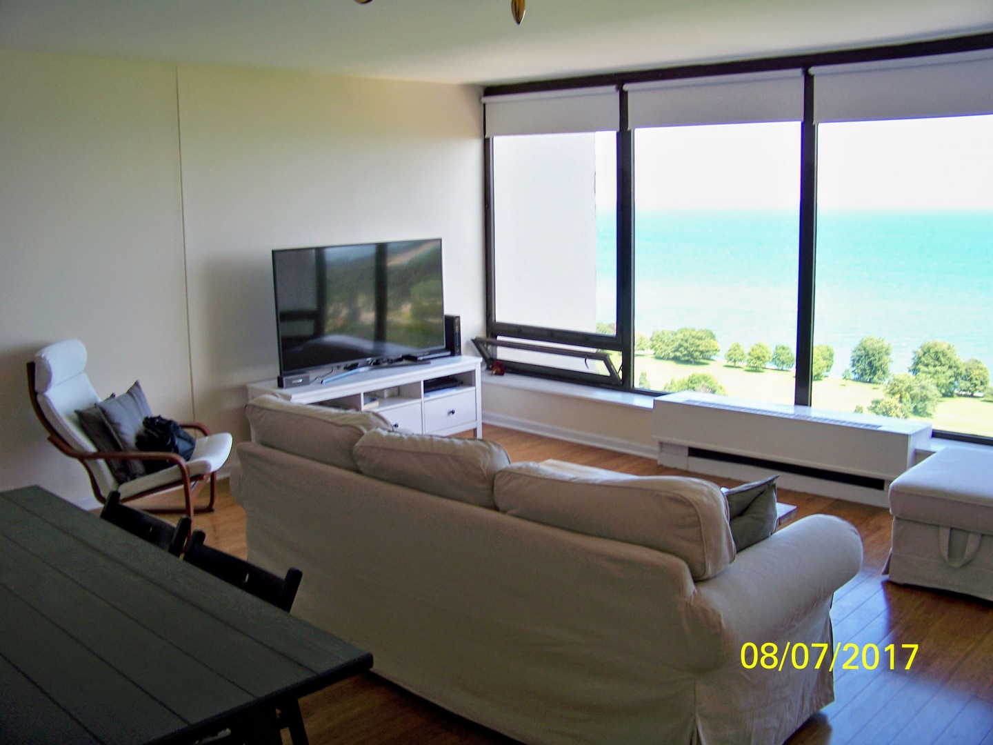 5445 North Sheridan Road, Unit 2504 Chicago, IL 60640 - Photo 5 of 37 a living room with furniture and a flat screen tv