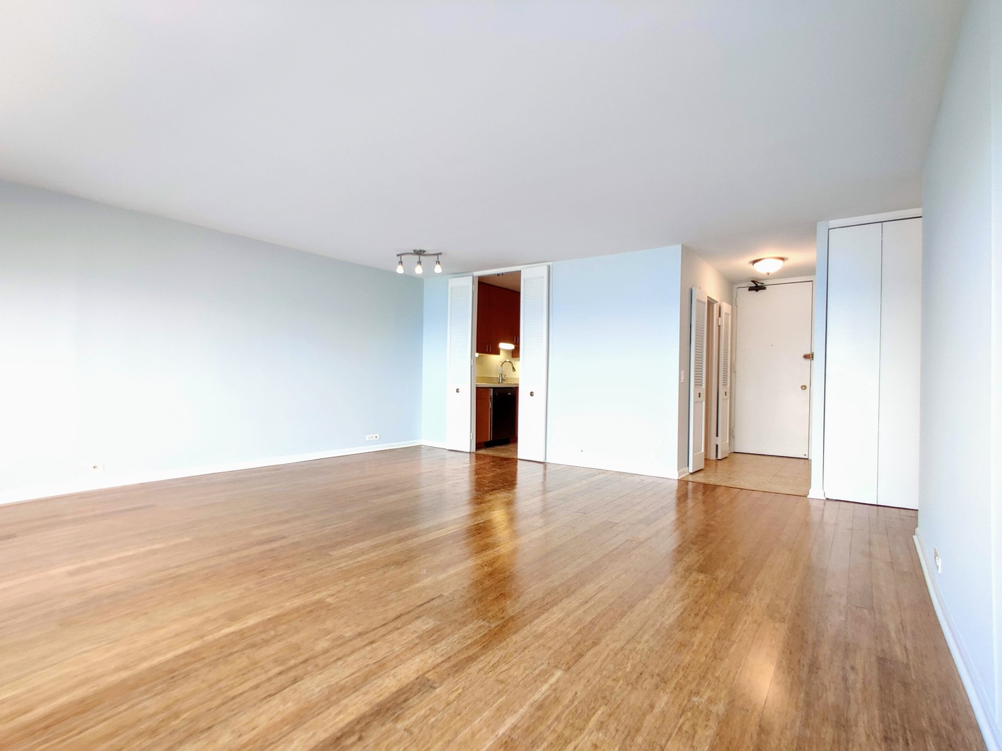 5445 North Sheridan Road, Unit 2504 Chicago, IL 60640 - Photo 6 of 37 a view of empty room with wooden floor and kitchen
