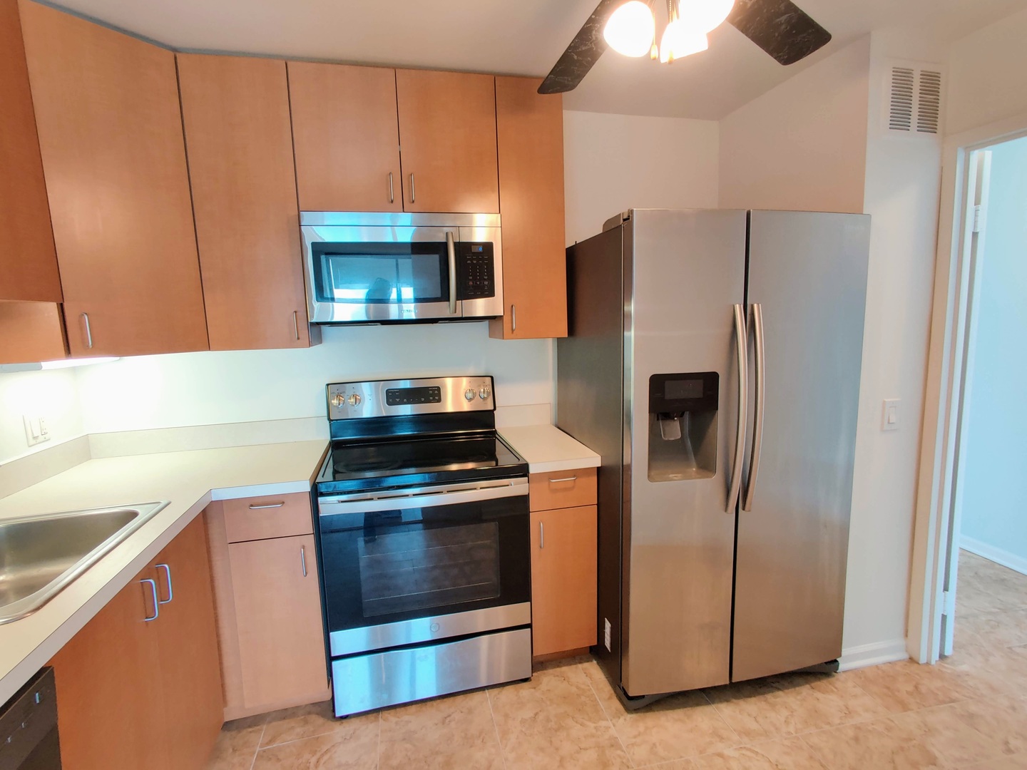 5445 North Sheridan Road, Unit 2504 Chicago, IL 60640 - Photo 7 of 37 a kitchen with stainless steel appliances a stove a microwave and a refrigerator