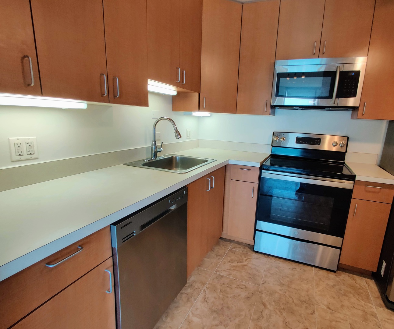 5445 North Sheridan Road, Unit 2504 Chicago, IL 60640 - Photo 9 of 37 a kitchen with a stove microwave and sink