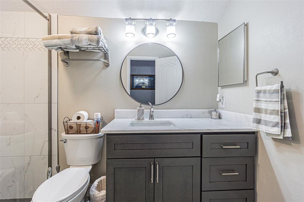 9809 La Rita Place Riverview, FL 33569 - Photo 35 of 59 a bathroom with a toilet a sink and mirror