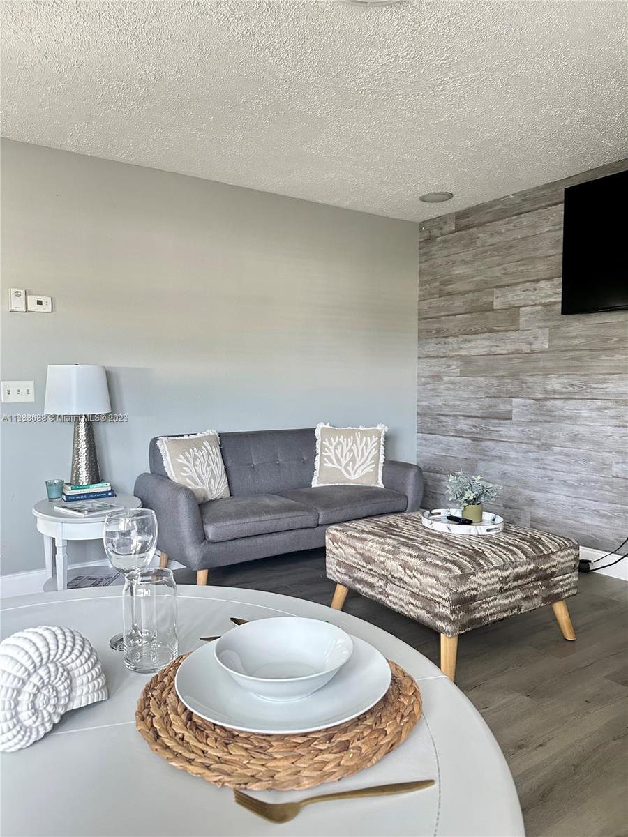 300 E Circle Jupiter, FL 33458 - Photo 12 of 28 a living room with furniture and a fireplace