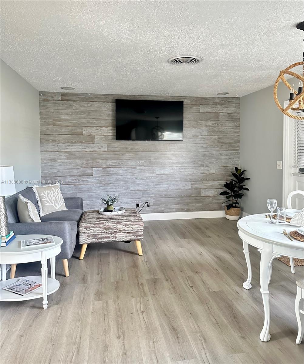 300 E Circle Jupiter, FL 33458 - Photo 14 of 28 a living room with furniture and a flat screen tv