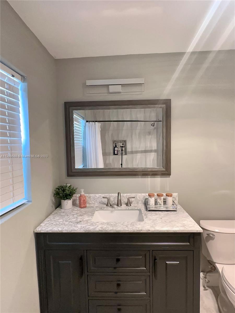 300 E Circle Jupiter, FL 33458 - Photo 16 of 28 a bathroom with a sink and a mirror